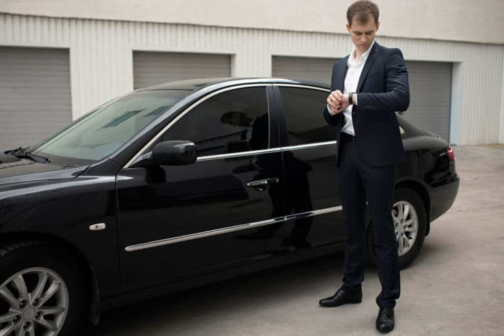 elegant-man-standing-his-car-taxi-services_23-2149149593